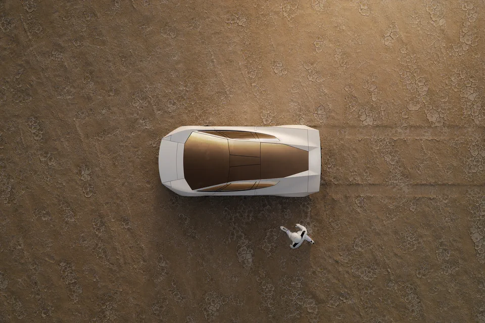 Roadster from directly above on a desert floor, its gold-tinted canopy beside an astronaut.