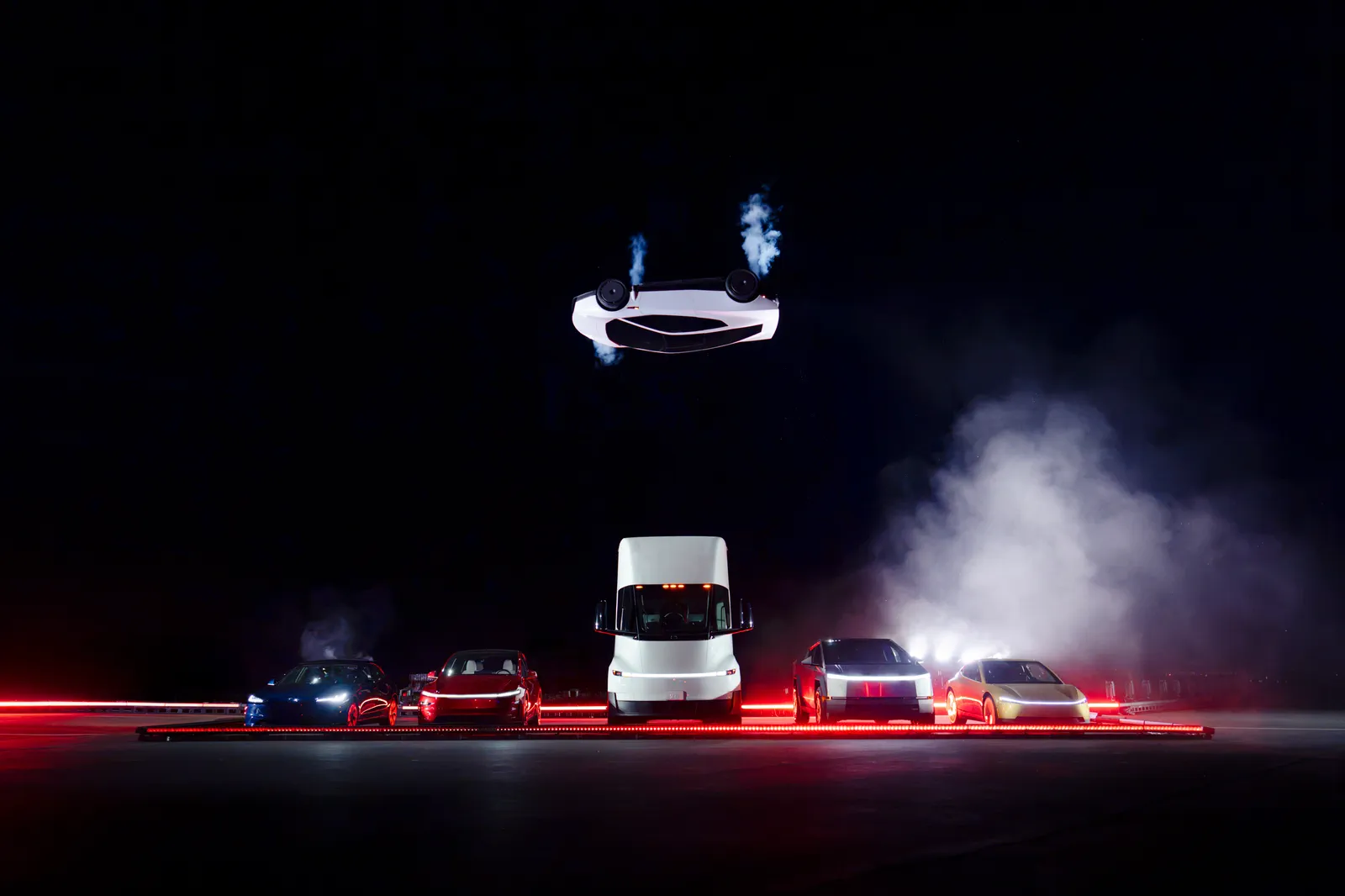 Roadster upside down at the top of its arc above the Semi and the lineup.