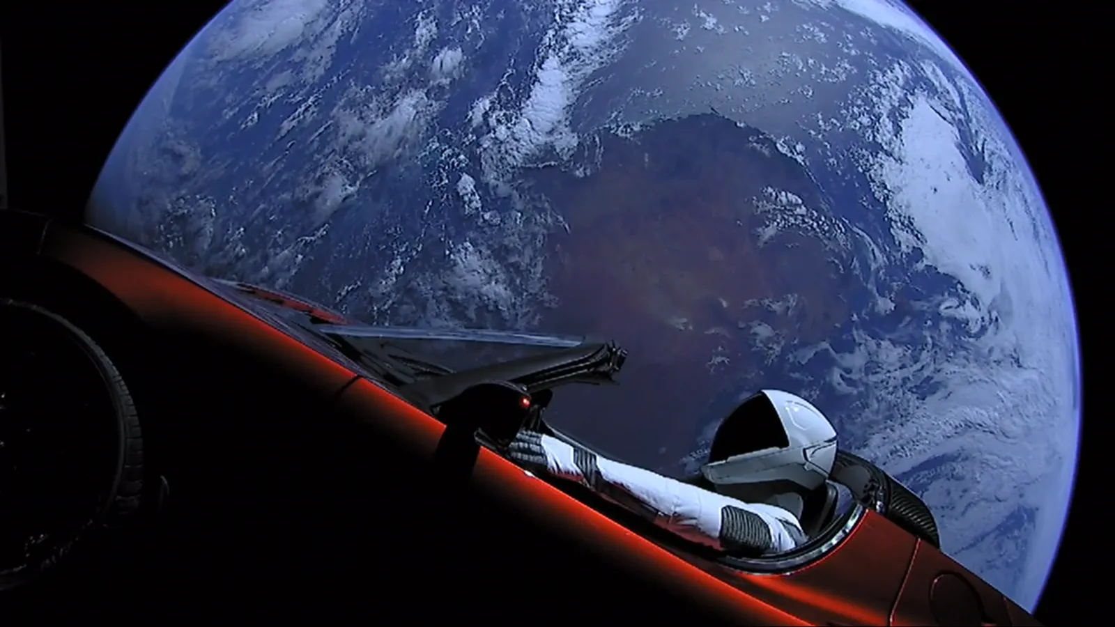 The original 2008 Roadster in orbit, Starman at the wheel, Earth behind.