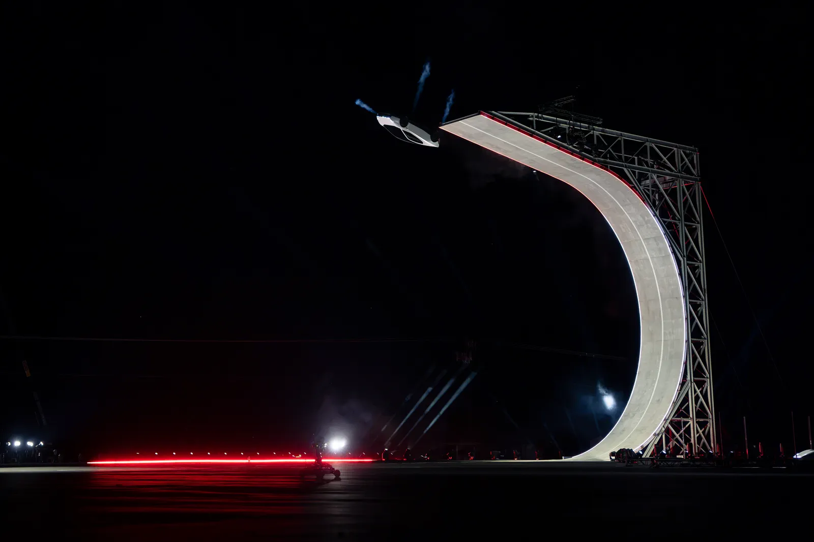 Roadster leaving the lip of the curved wall, thrusters firing.