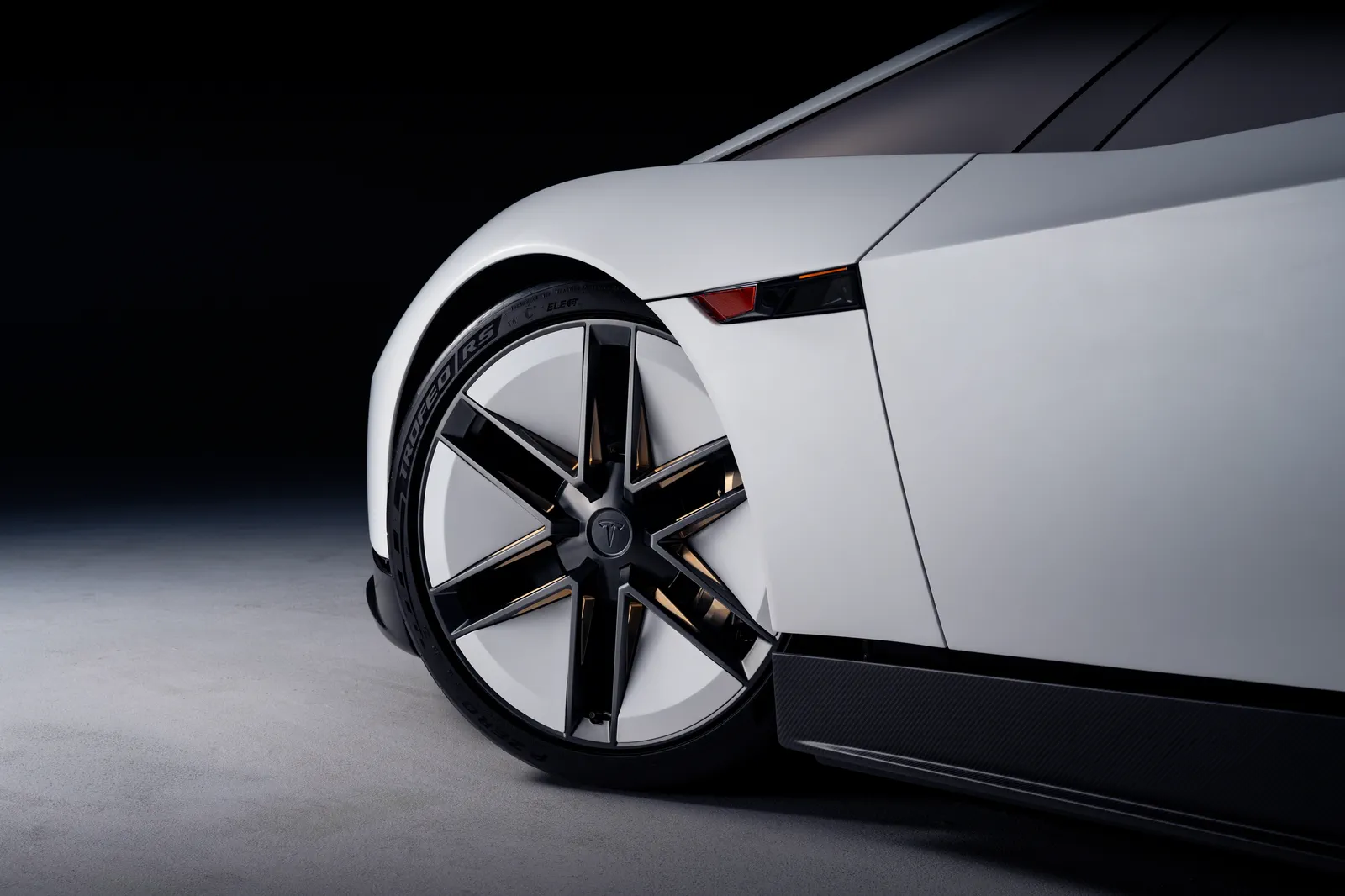 Close-up of a thin-spoked wheel with gold accents.