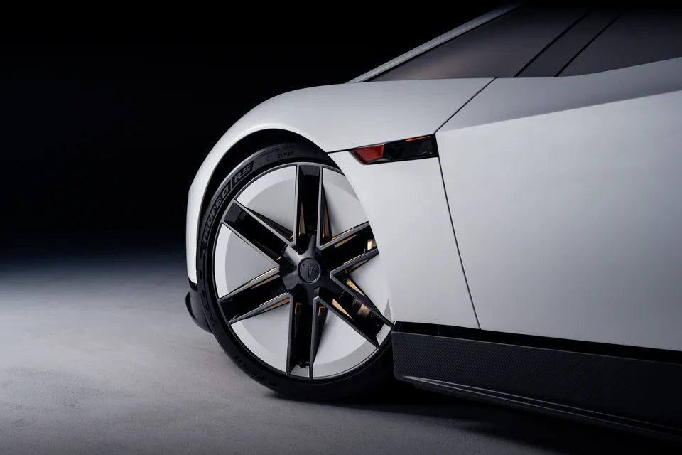 Close-up of a thin-spoked wheel with gold accents.